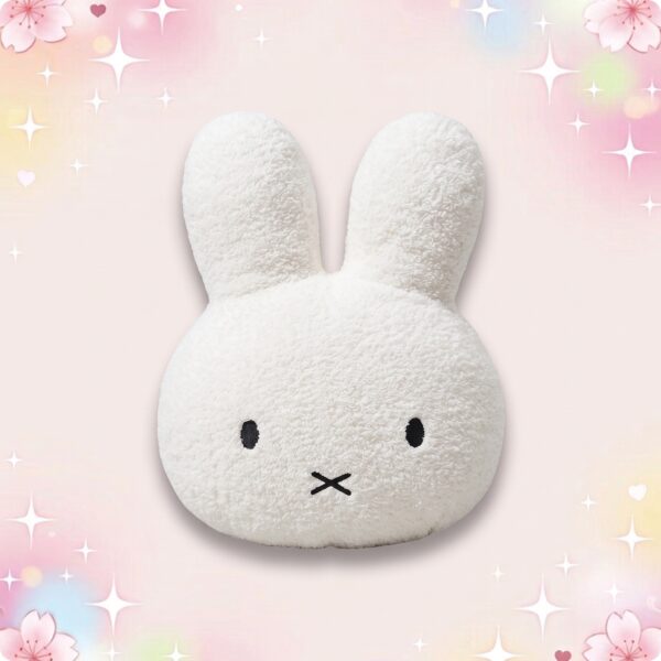 Une peluche kawaii géante lapin Miffy blanche, avec de grandes oreilles et un petit visage brodé, sur un fond rose pastel avec des étoiles brillantes.