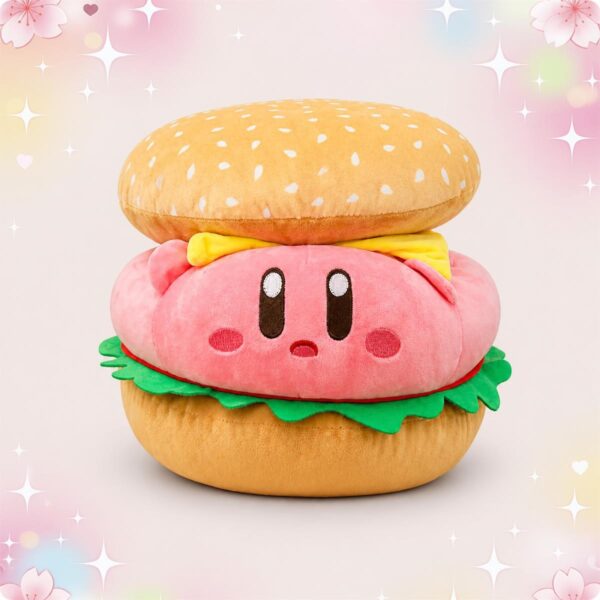 Une peluche Kirby en forme de burger rose, avec un grand pain du dessus, de la salade verte et un fond pastel avec des petites étoiles.