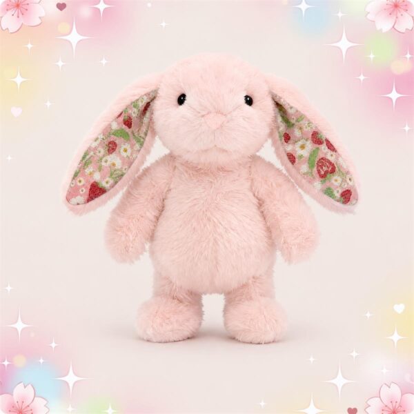 Une peluche lapin Kawaii aux oreilles à motifs colorés, rose et toute douce, debout sur un fond pastel avec des petits cœurs et des fleurs.