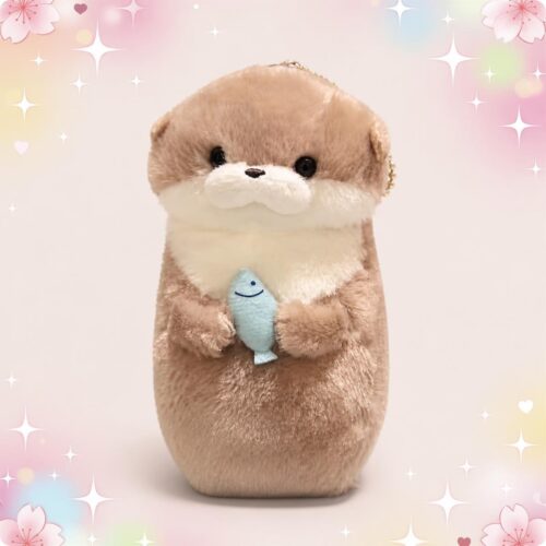 Une petite peluche loutre porte-clé étreignant un poisson bleu, toute douce, sur un fond rose avec des étoiles et des cœurs.