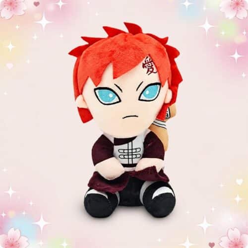 Une peluche Gaara de l'anime Naruto position assise, avec les cheveux rouges, de grands yeux bleus et un petit costume, posée sur un fond rose décoré d’étoiles et de fleurs.