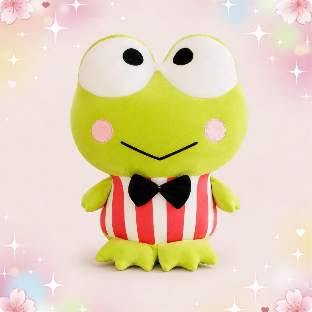 Une peluche grenouille portant un noeud papillon, avec de grands yeux ronds, un ventre rayé rouge et blanc, sur un fond rose décoré de petites étoiles et de cœurs.