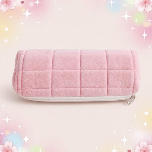 Une trousse Kawaii matelassée en format rectangulaire rose, douce et rembourrée, avec fermeture éclair, sur un fond pastel décoré d’étoiles et de fleurs.