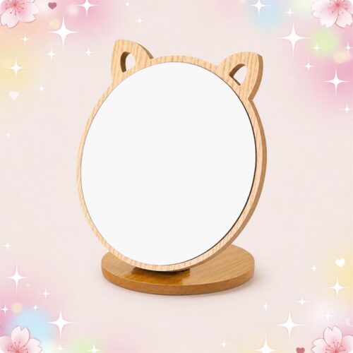 Un miroir de maquillage en bois pliable et rotatif avec oreilles de chat, posé sur un socle rond en bois, sur un fond rose doux et décoré d’étoiles scintillantes.