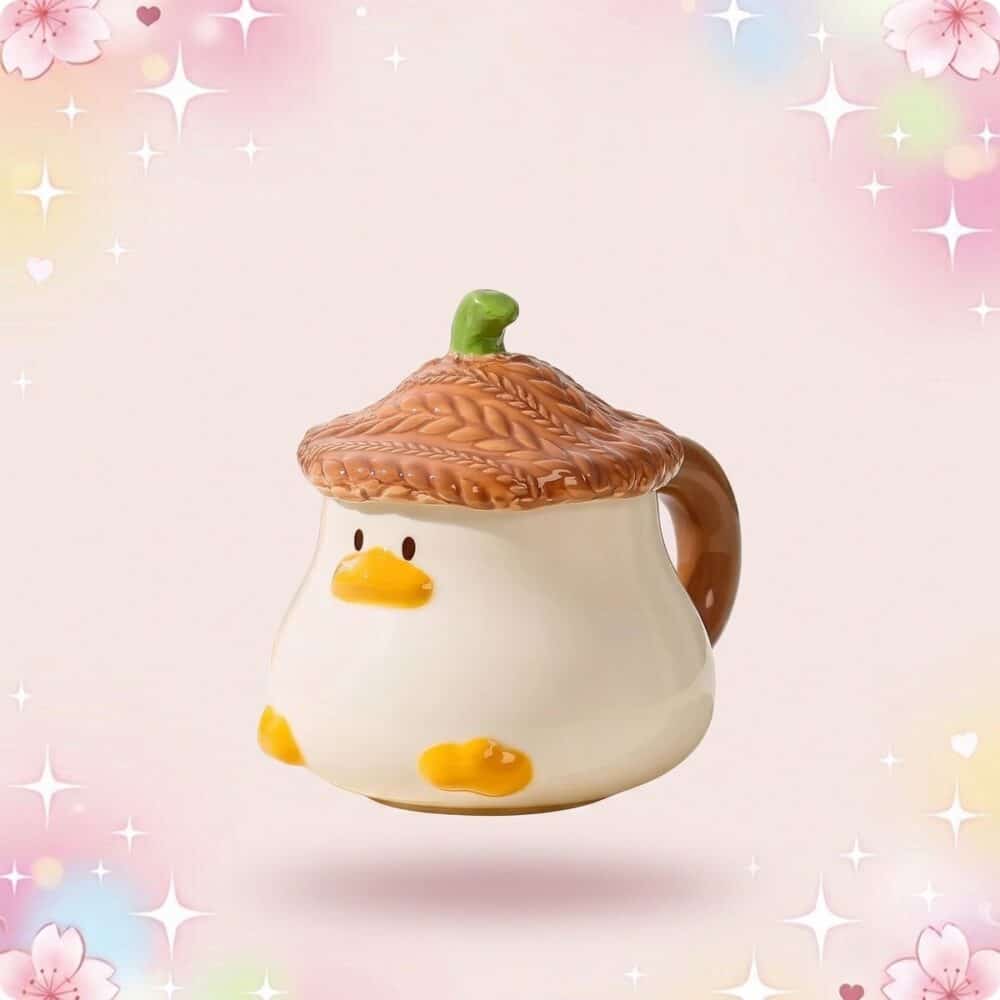 Un mug kawaii canard mignon en forme de petit canard, avec un couvercle gland et une anse marron, sur fond rose pastel scintillant.