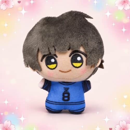 Un porte-clés peluche Bachira de Blue Lock en forme de petit personnage aux cheveux bruns et aux grands yeux, vêtu d’un maillot de football bleu numéro 8, sur un fond pastel décoré de fleurs et d’étoiles.